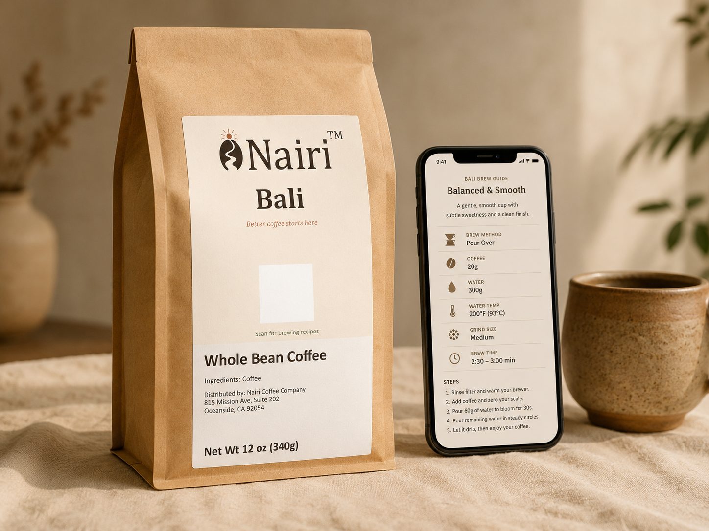 A Nairi coffee bag on cream linen beside a phone showing the coffee's brewing recipe.